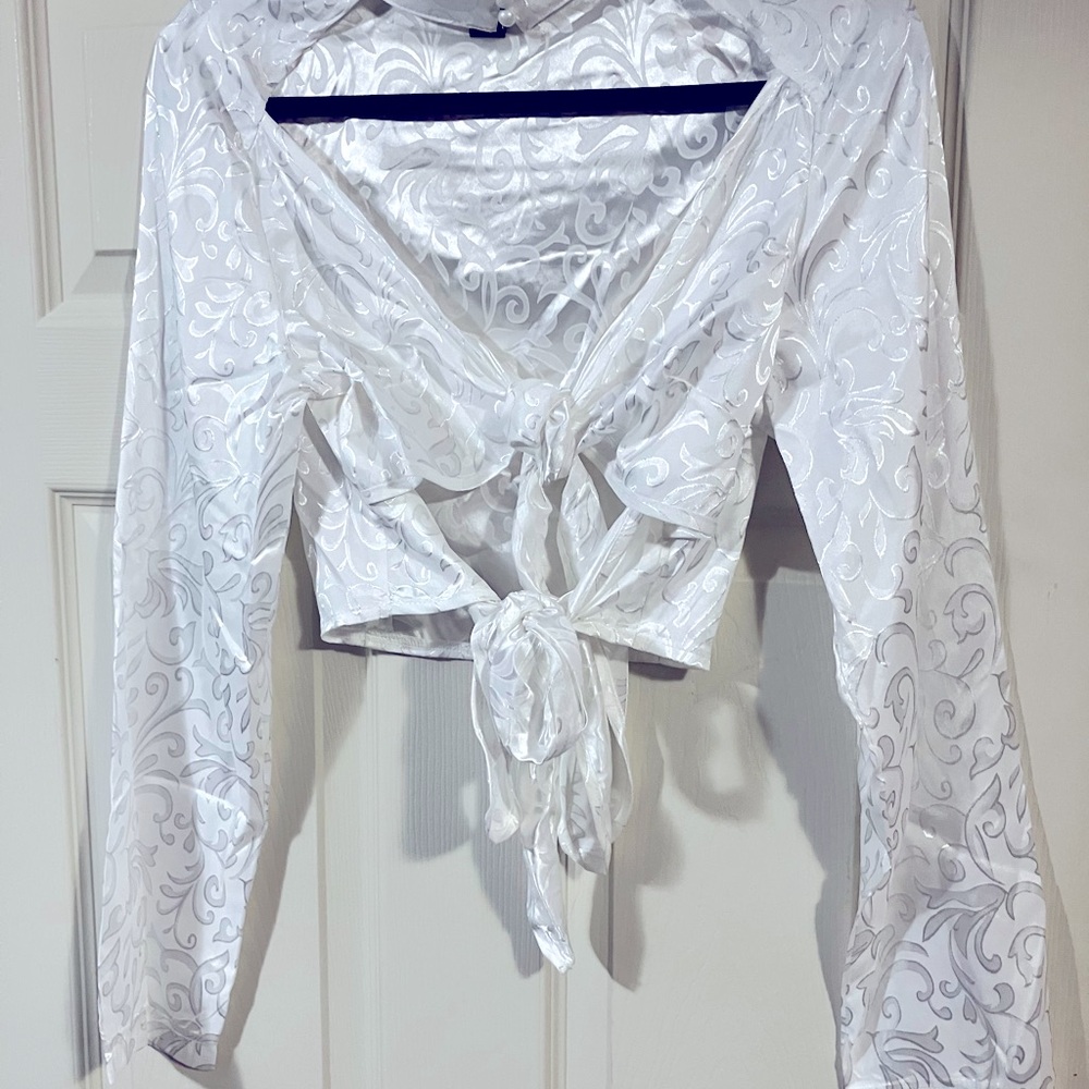 White jacquard satin print crop top with pearl button detail. Two large bows.